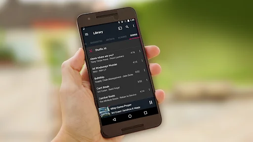Fuel Music Player app displaying dark themed playlist with song list and playback controls at bottom